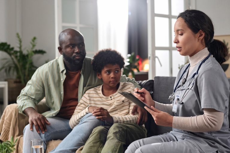 Nurse Consulting Parent and Child at Home